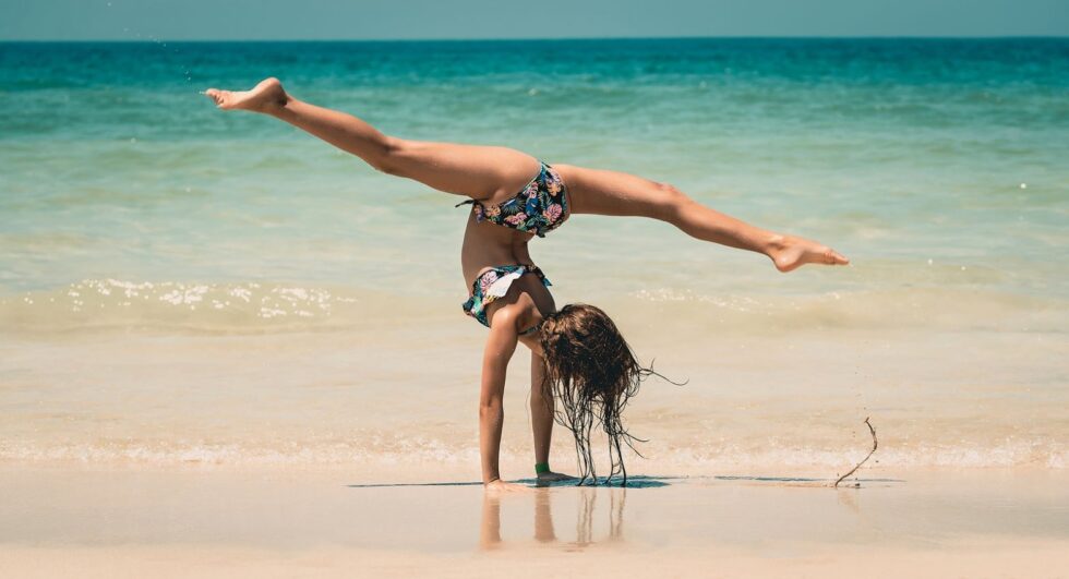 Boardwalk Resort Vacations highlights an active beach moment as part of staying active while traveling.